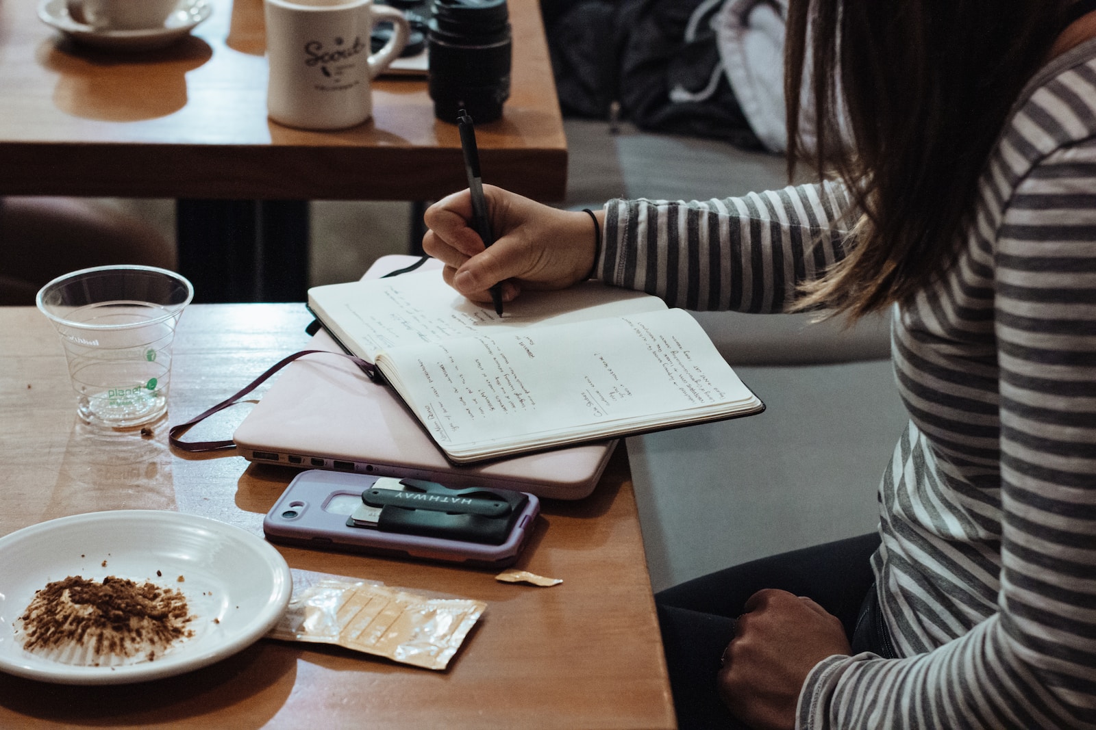 woman writing on notebook